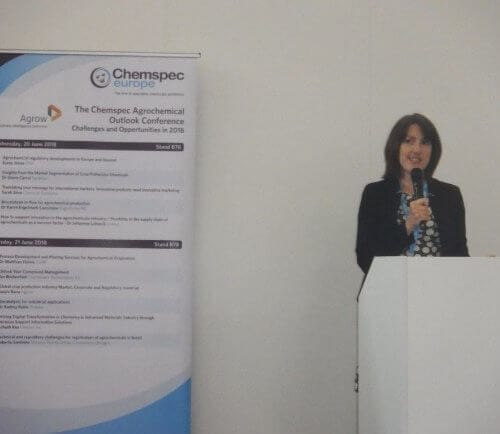 Sarah Silva presenting at a podium at Chemspec Europe